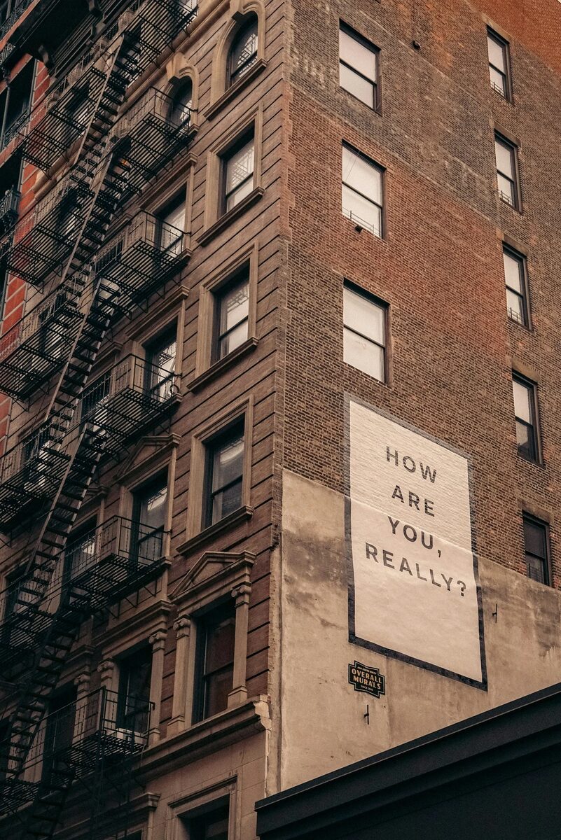 A building sign that reads: How are you, really?